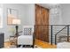 Cozy hallway seating area with textured walls and modern lighting fixture at 4451 Eliot St, Denver, CO 80211