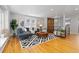 Open-concept living area with hardwood floors, stylish furnishings, and a decorative wood accent wall at 4451 Eliot St, Denver, CO 80211