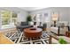 Bright and airy living room with large windows, wood floors, and a spacious layout for relaxation and socializing at 4451 Eliot St, Denver, CO 80211
