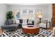 Cozy living area featuring hardwood floors, large windows, and an abundance of seating at 4451 Eliot St, Denver, CO 80211