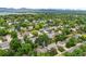 Beautiful aerial view of a suburban neighborhood with mature trees and mountain views at 4677 S Wolff St, Denver, CO 80236