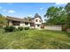 Picture of a spacious backyard, showcasing the home's exterior, a shed, and lush green space perfect for outdoor activities at 4677 S Wolff St, Denver, CO 80236