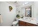 Traditional bathroom with a single vanity and a decorative floral wallpaper border at 4677 S Wolff St, Denver, CO 80236