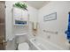 Bathroom with a white tub/shower combination and a floral wallpaper border at 4677 S Wolff St, Denver, CO 80236