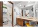 An older bathroom with a vanity and a shower and bath combination tub at 4677 S Wolff St, Denver, CO 80236