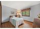 Bedroom with hardwood floors, a gray accent wall and a large window at 4677 S Wolff St, Denver, CO 80236