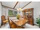Traditional dining room featuring a wooden table, chandelier, and large china cabinet at 4677 S Wolff St, Denver, CO 80236