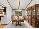 Elegant dining room with a chandelier, wood table, and upholstered chairs at 4677 S Wolff St, Denver, CO 80236