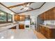 Charming kitchen featuring wood cabinets, white appliances, and a breakfast bar area at 4677 S Wolff St, Denver, CO 80236