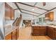 Spacious kitchen with wood cabinets, granite countertops, and an open layout to the living area at 4677 S Wolff St, Denver, CO 80236