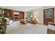 Cozy living room featuring a brick fireplace, built-in bookshelves, and comfortable seating at 4677 S Wolff St, Denver, CO 80236