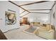 Bright living room with vaulted ceilings, exposed beams, and comfortable seating at 4677 S Wolff St, Denver, CO 80236
