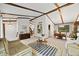 Bright living room with vaulted ceilings, exposed beams, and comfortable seating at 4677 S Wolff St, Denver, CO 80236
