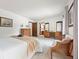 Spacious main bedroom with sitting area, carpet and decorative dressers at 4677 S Wolff St, Denver, CO 80236