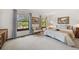 The main bedroom has two windows, carpet floors and a queen bed at 4677 S Wolff St, Denver, CO 80236