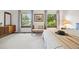 The main bedroom has two windows, carpet floors and a queen bed at 4677 S Wolff St, Denver, CO 80236
