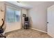 Minimalist bedroom with neutral walls, window, closet and arcade game, perfect for work and play at 8445 S Holland Way # 205, Littleton, CO 80128