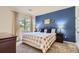 Comfortable bedroom featuring a queen bed, neutral decor, and plenty of natural light from the window at 8445 S Holland Way # 205, Littleton, CO 80128