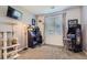 Functional bedroom with computer desk, chair, TV, cat tower, arcade game, and plenty of natural light at 8445 S Holland Way # 205, Littleton, CO 80128