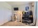 Bright, multi-purpose bedroom features a modern desk, cat tower, a closet, and a large window at 8445 S Holland Way # 205, Littleton, CO 80128
