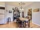 Well-lit dining room area with hardwood floors, dark wood furniture, and charming decor at 8445 S Holland Way # 205, Littleton, CO 80128