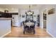 Bright dining area with wood floors, vintage furniture, decorative wall art, and an open layout at 8445 S Holland Way # 205, Littleton, CO 80128