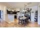 Open-concept dining area featuring hardwood floors, classic dining set, and stylish decor at 8445 S Holland Way # 205, Littleton, CO 80128