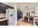 Open-concept kitchen and dining area with modern appliances, wood floors, and stylish decor at 8445 S Holland Way # 205, Littleton, CO 80128