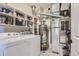 Bright laundry room with washer, dryer, shelving, water heater and HVAC system at 8445 S Holland Way # 205, Littleton, CO 80128