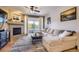 Bright living room with a cozy fireplace, plush sectional sofa and a sliding glass door with a balcony at 8445 S Holland Way # 205, Littleton, CO 80128
