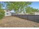 Spacious backyard with a modern fence and a mature tree at 947 S Yates St, Denver, CO 80219