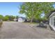 Spacious backyard featuring ample parking, a patio area, and mature trees at 947 S Yates St, Denver, CO 80219