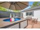 Backyard featuring a compact pool, modern patio, and outdoor seating area at 947 S Yates St, Denver, CO 80219