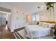 Bright bedroom with white closet, a large window, and hardwood floors at 947 S Yates St, Denver, CO 80219