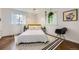 Bright bedroom with white walls, a large window, and a black and white rug at 947 S Yates St, Denver, CO 80219