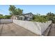 Street view of the home's exterior showing a white picket fence and a paved driveway at 947 S Yates St, Denver, CO 80219