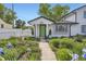 Charming home with a landscaped front yard, white picket fence, and a bright green front door at 947 S Yates St, Denver, CO 80219