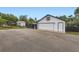 Detached garage with a white exterior and an asphalt driveway at 947 S Yates St, Denver, CO 80219