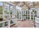 Bright greenhouse with tables and glass walls with a view of the yard at 947 S Yates St, Denver, CO 80219