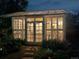 Illuminated greenhouse at night with lovely landscaping at 947 S Yates St, Denver, CO 80219