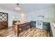 Bright kitchen with a wooden island, white cabinets, a retro stove, and wooden floors at 947 S Yates St, Denver, CO 80219