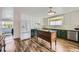Updated kitchen featuring white cabinets, appliances, and a central butcher block island at 947 S Yates St, Denver, CO 80219