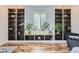 Built-in bookshelves flank a window creating a cozy and stylish living space at 947 S Yates St, Denver, CO 80219