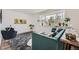 Bright and airy living room featuring a plush sofa, plants, and large windows at 947 S Yates St, Denver, CO 80219