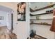 Pantry with open shelving and a door to a hall at 947 S Yates St, Denver, CO 80219