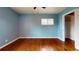 Light blue bedroom with hardwood floors and a closet at 4530 W Hamilton Pl, Denver, CO 80236