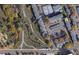 Aerial view of condo community with a nearby trail, trees, and street access at 7665 E Eastman Ave # 210, Denver, CO 80231