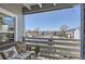 Relaxing balcony with comfortable seating and views of the surrounding community and parking area at 7665 E Eastman Ave # 210, Denver, CO 80231