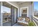 Inviting balcony featuring cozy furniture, offering a serene outdoor living space with views of trees at 7665 E Eastman Ave # 210, Denver, CO 80231