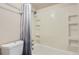 The well-maintained bathroom features a shower, bathtub, and built-in shelving at 7665 E Eastman Ave # 210, Denver, CO 80231